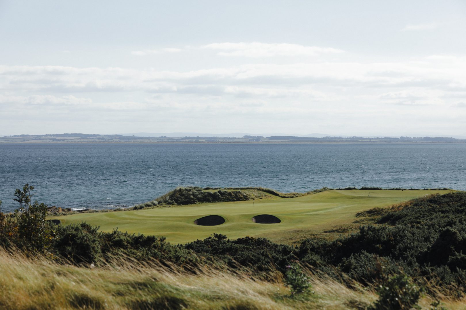 Royal Dornoch Golf Course in the Highlands with the 9th green overlooking the Moray Firth by AKH Golf Photography