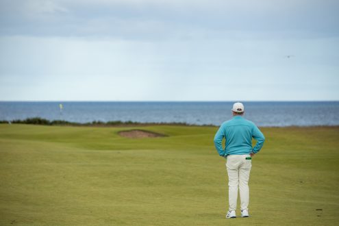 Golfer looking from the fairway towards a green at Royal Dornoch