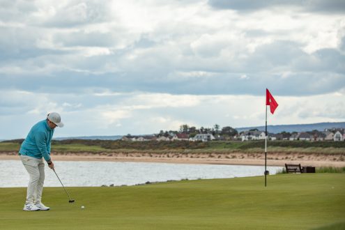 Golfer putting on the 10th green at Royal Dornoch