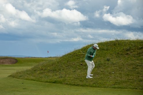 Golfer playing an approach shot to the 15th hole at Royal Dornoch