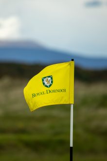 Close-up of a Royal Dornoch golf flag blowing in the wind